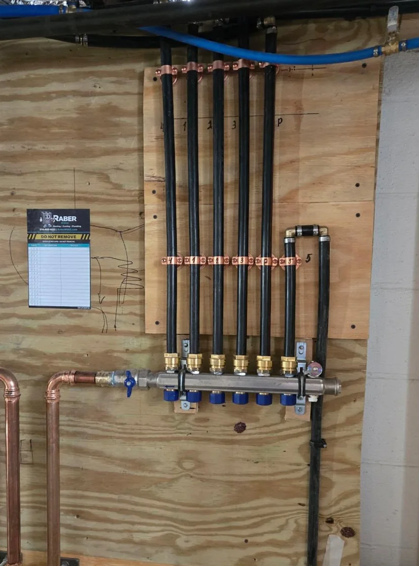 PEX manifold on a whole home repipe with every run labelled at the trunk