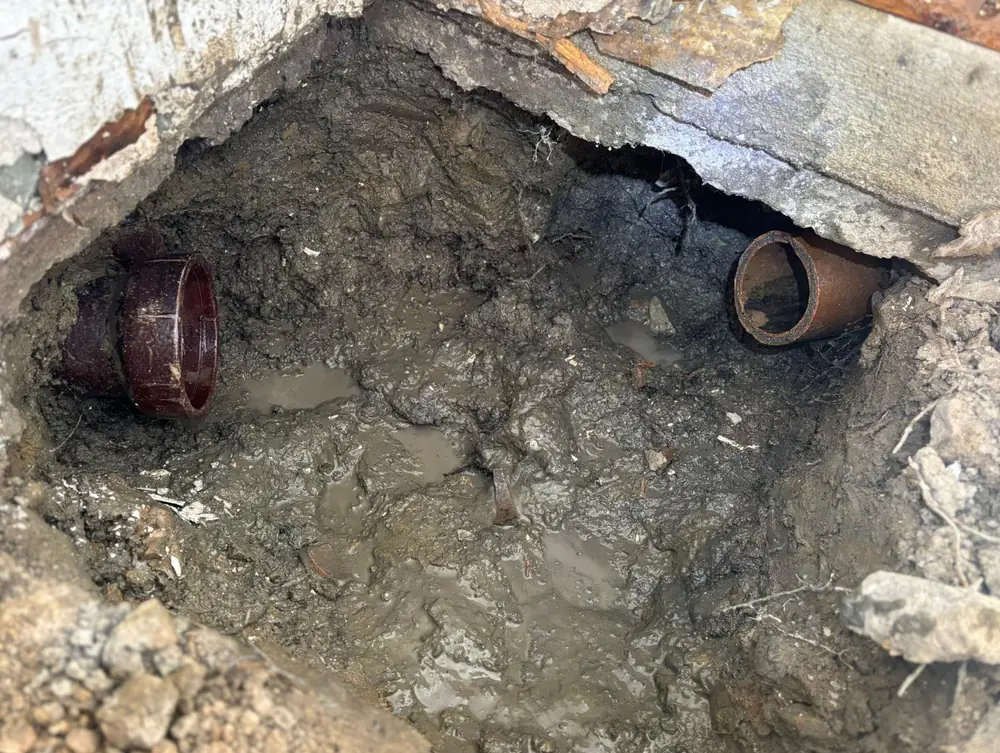 Raber crew working an open excavation to replace a broken sewer lateral on a Northeast Ohio street