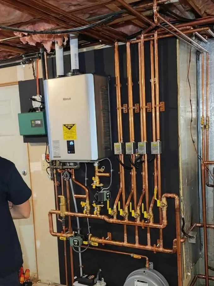 Mechanical room equipment installed by Raber HVAC with accessible isolation valves and tidy copper runs